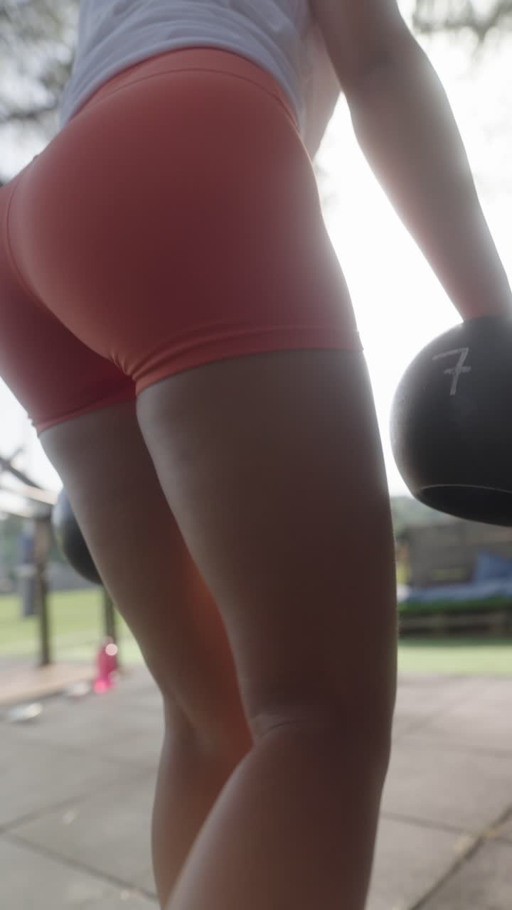 Woman lifting weights in fitness workout