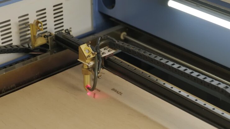 Cnc laser cutting machine cuts wooden plank and plywood