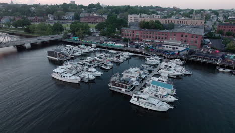 Aerial-orbit-video-over-boat-docks-south-of-Providence-RI-with-buildings-visible-at-the-end