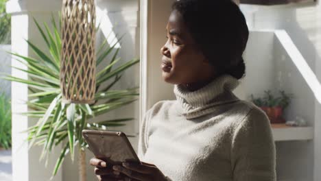 Video-of-african-american-woman-using-tablet-at-home