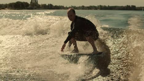 wake surfing rider training stunt. wakesurfer falling into water