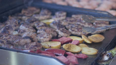 grilled meat and potatoes on a grill