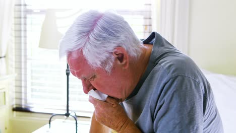Sick-senior-man-coughing-in-bedroom