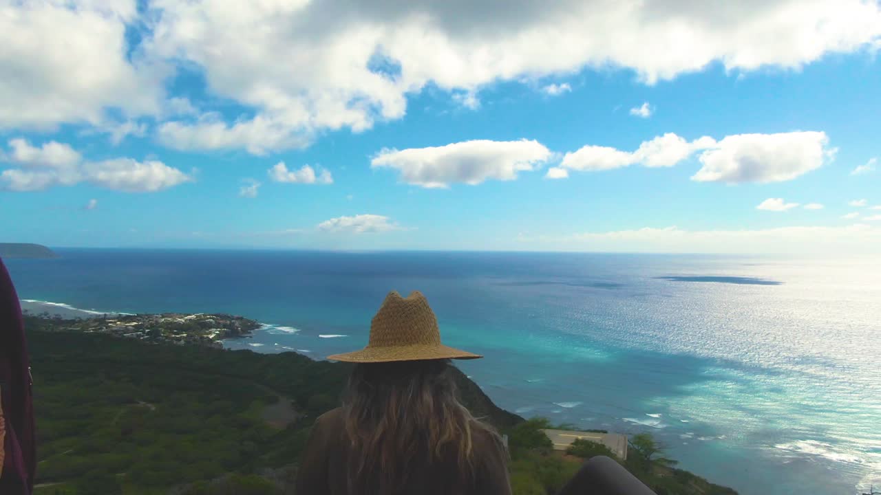 Tourists walking on Diamond Read volcano trail, Honolulu, USA. Handheld