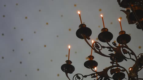 candle flame close-up in the indian temple on a religious festival diwali. oil lamp in beautiful candlestick. spiritual, mystical and religious traditions of india. beautiful bright festive lights