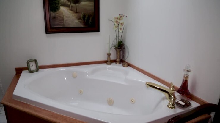 A Bathtub with a brass faucet