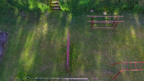 Vintage outdoor gym in local park on sunny day, aerial top down view