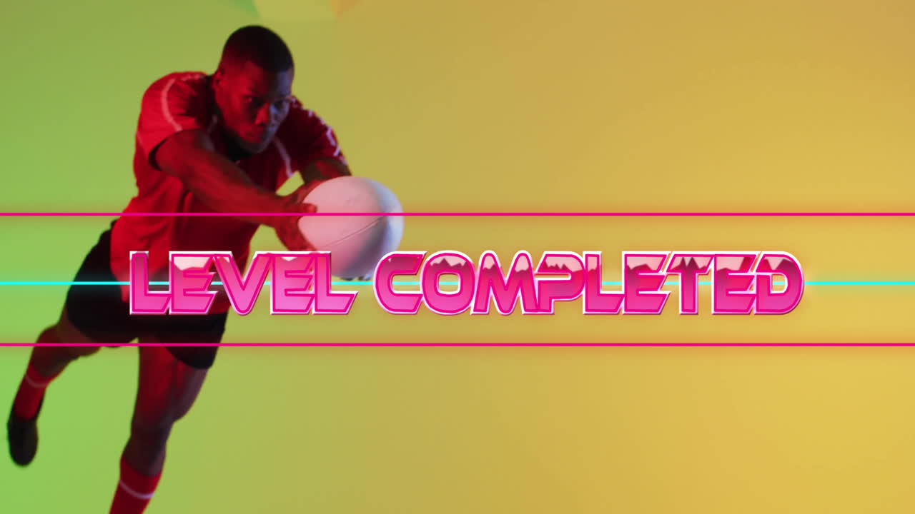 Animation of level completed over african american male rugby player on yellow background