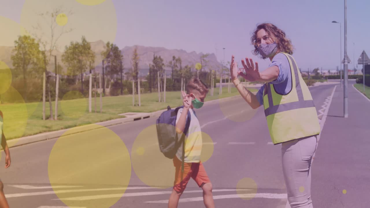 Animation of falling icons over happy caucasian boy crossing the street