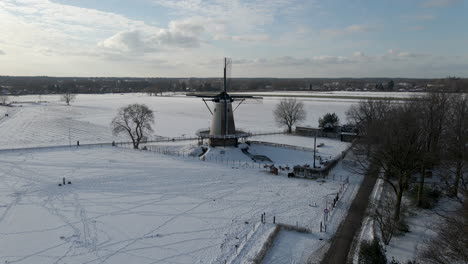 high jib up of traditional windmill in rural snow covered landscape