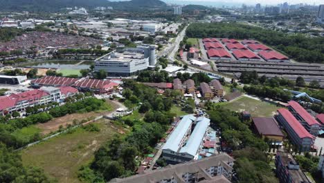 Drone-shot-slow-fly-over-buildings-during-hot-afternoon