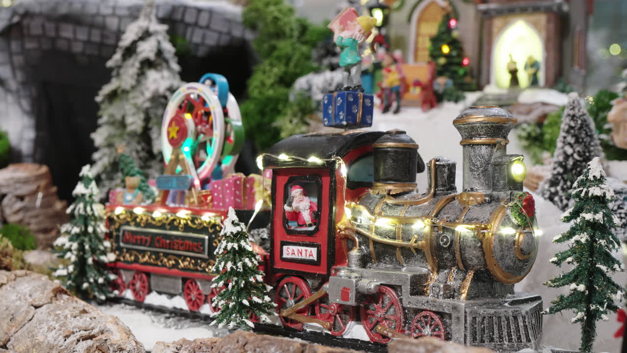 Christmas Toy Train with Santa Claus in a Snowy Miniature Village
