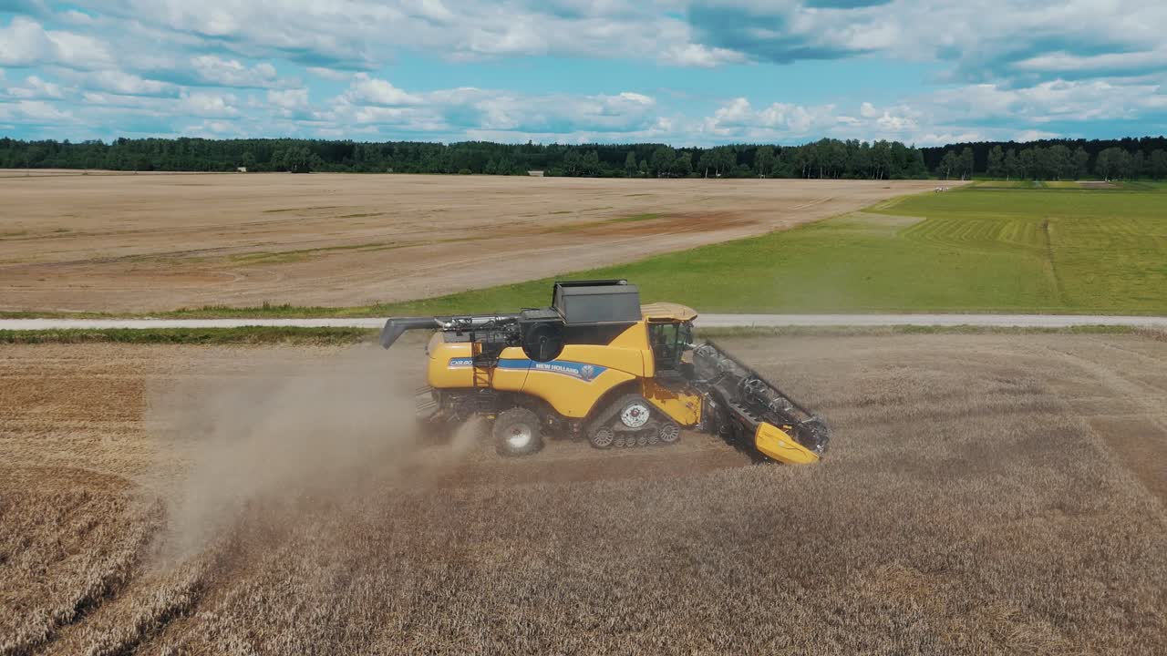 25 august 2024 Penkule, Latvia - Aerial View of Combine Harvester at Work. Summer Field Work on the Farm. Top View of Combine Gathering Corn or Wheat Crop.
