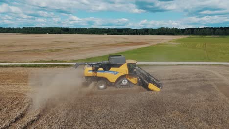 25 august 2024 penkule, latvia - aerial view of combine harvester at work. summer field work on the farm. top view of combine gathering corn or wheat crop.