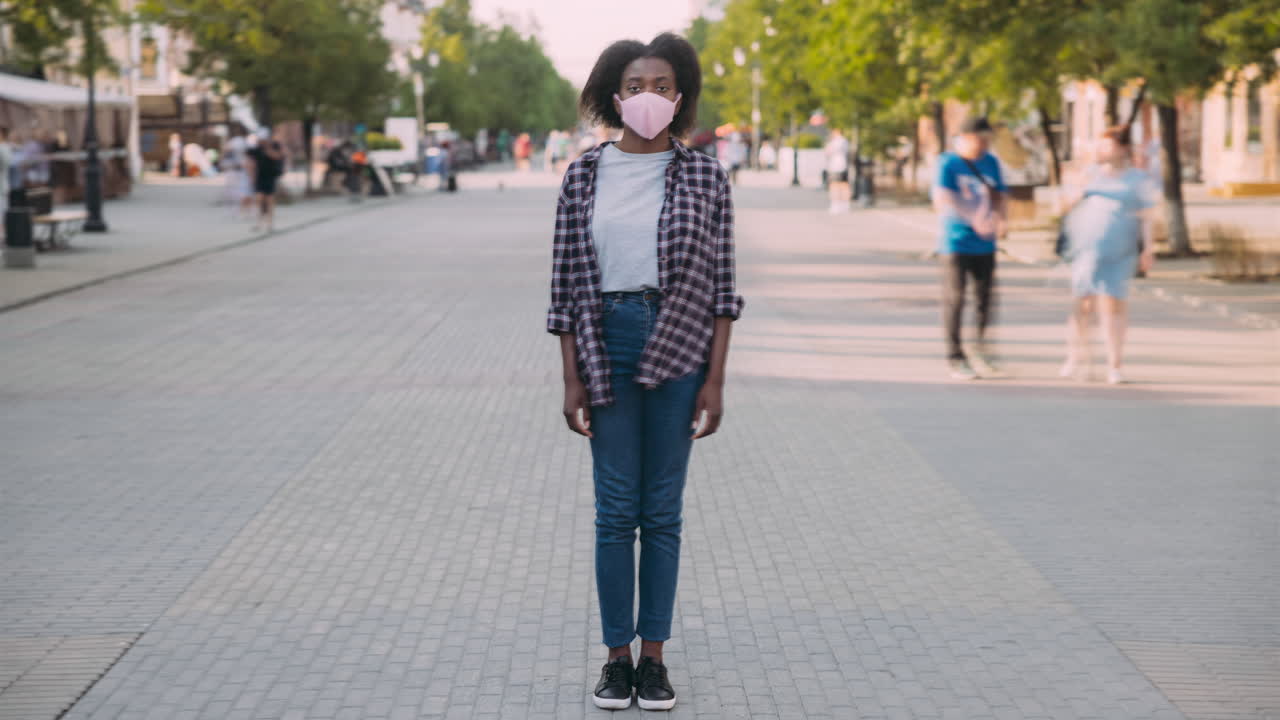 Young Woman Wearing Face Mask on City Street
