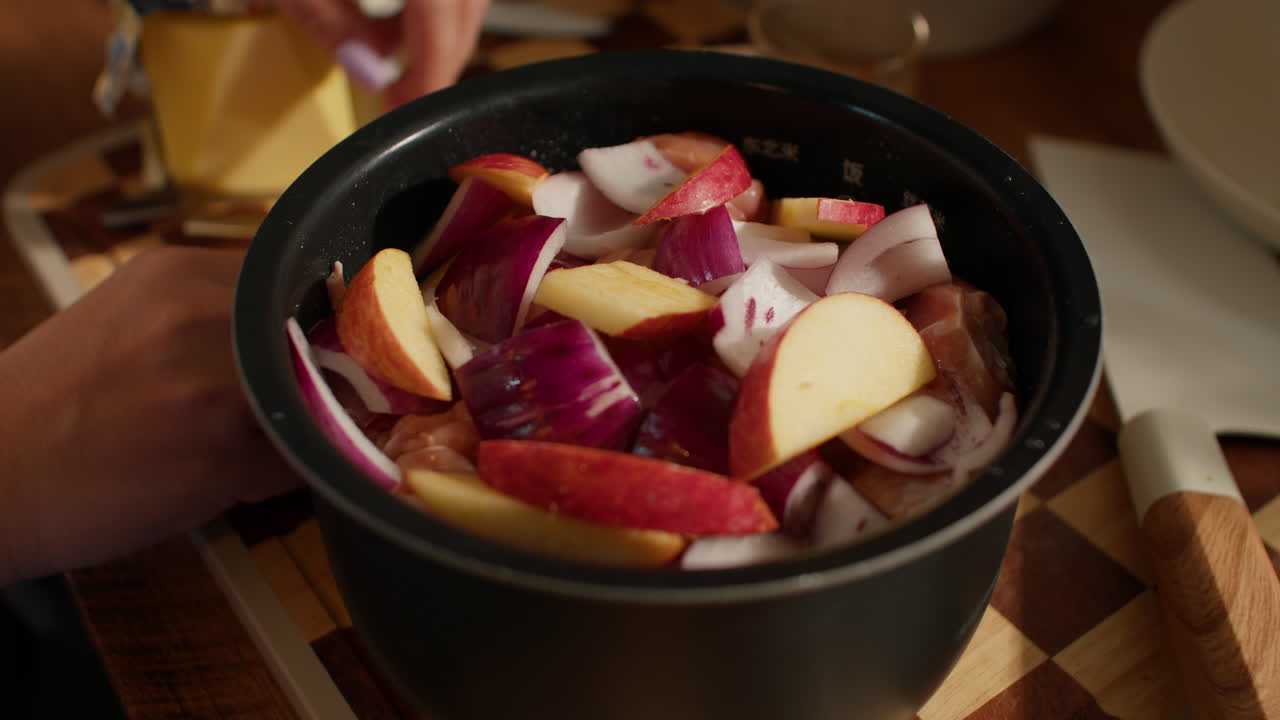 Placing apples and onions on a wooden board, preparing a fresh dish