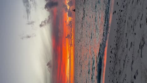 stunning vivid deep orange and red beach sunset: malahini kuda bandos, maldives