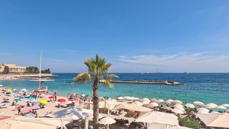 tourists enjoying a sunny beach in monte carlo