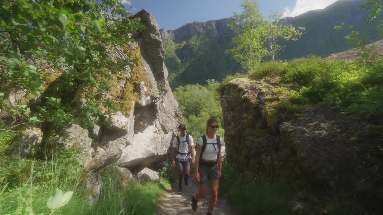 Two hikers on a scenic mountain trail