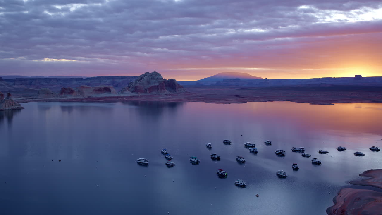 The aerial shot glides over Glen Canyon’s sculpted rock formations, offering a mesmerizing view of its geological wonders.