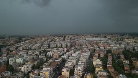 Aerial-drone-backward-moving-shot-of-dark-rain-clouds-over-residential-buildings-over-the-city-of-Rome-in-Italy-on-a-stormy-day