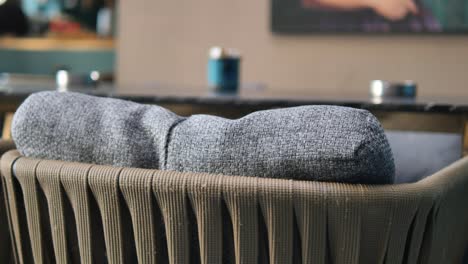 close up of a gray chair with cushions at a cafe