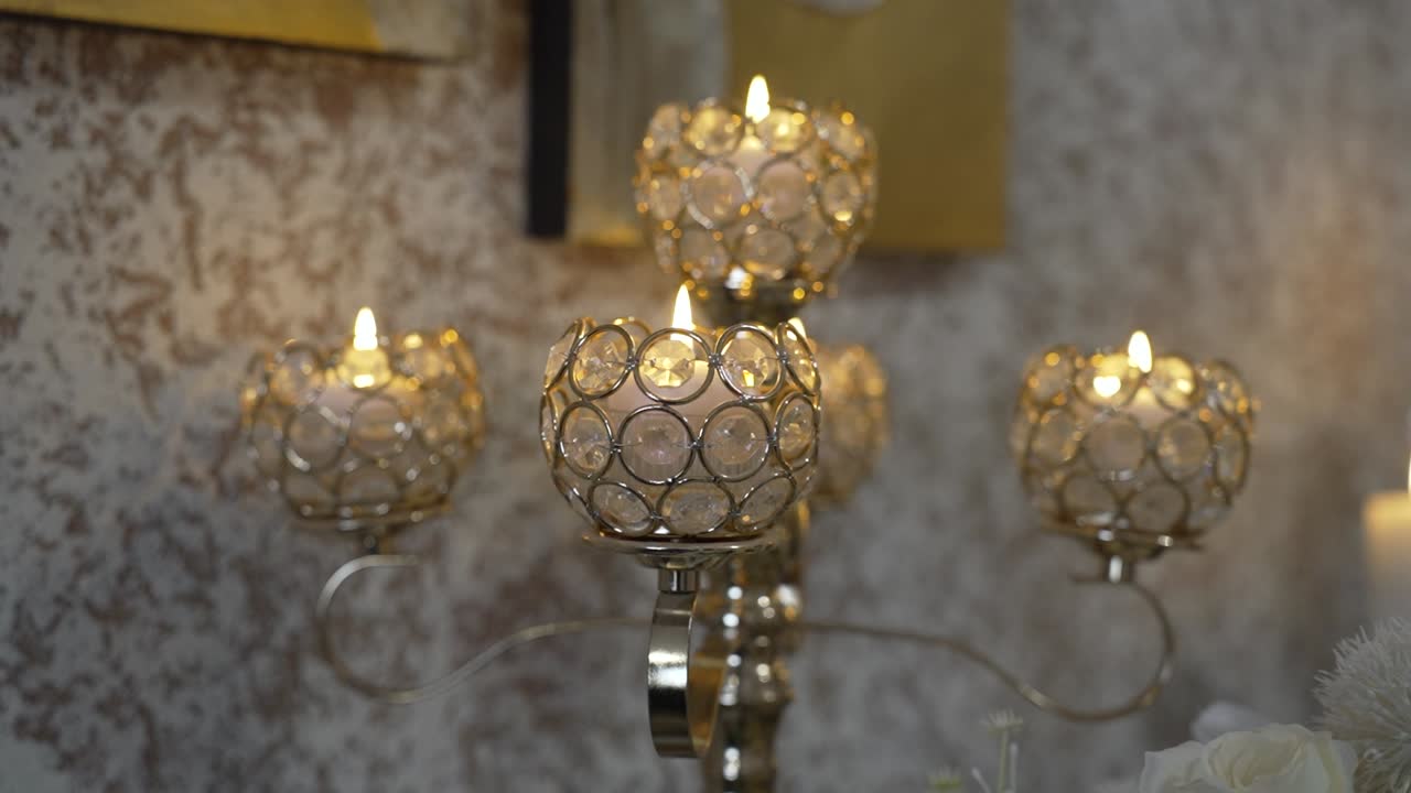 Burning Candles On A Crystal Candelabra Candle Holder Inside A Room. - closeup shot