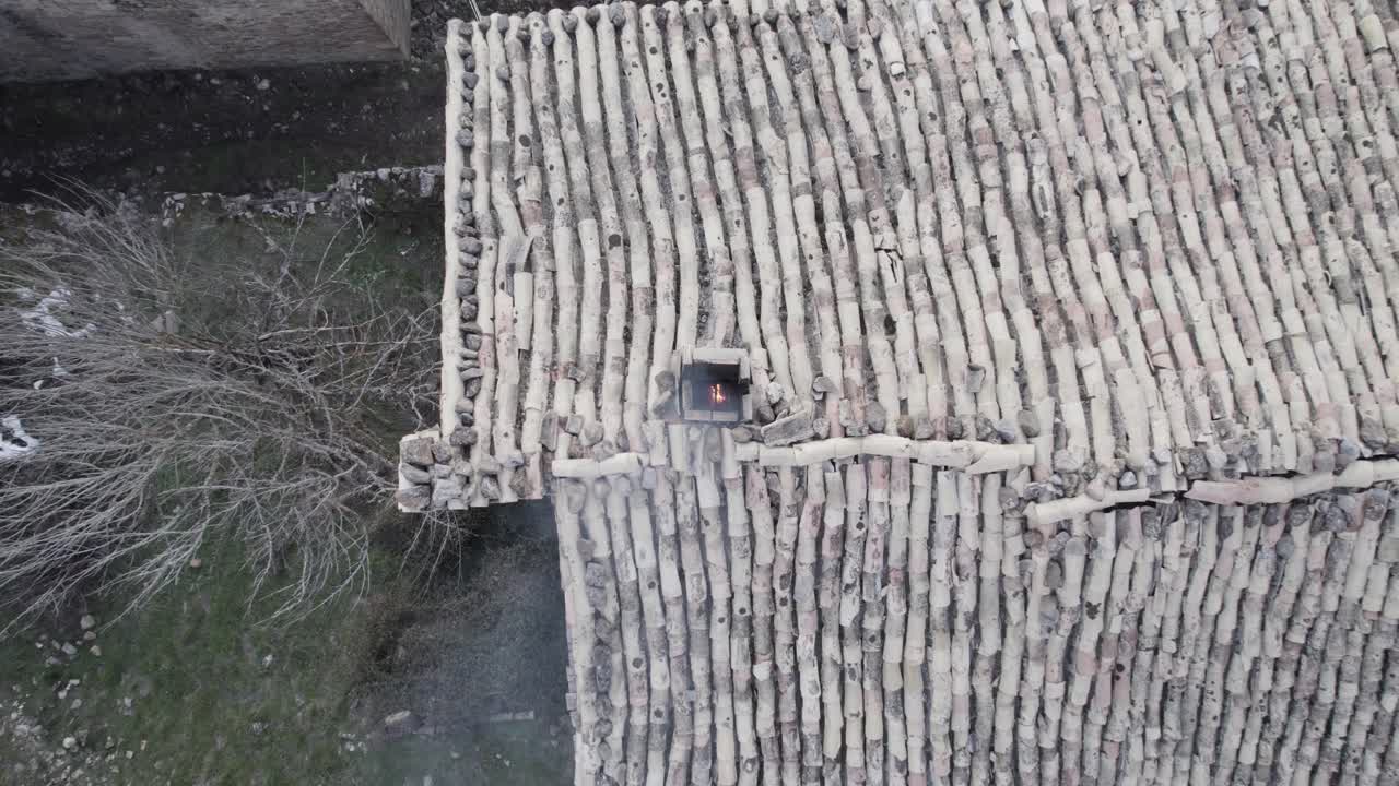 Smoldering smoky chimney with bamboo roof and wall of local old house