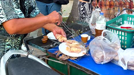 vendor grilling and serving food on the street