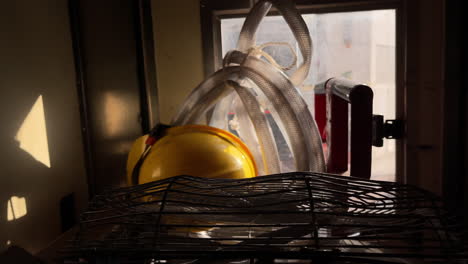 Static-shot-of-yellow-helmet-and-other-equipment-in-a-moving-mini-bus