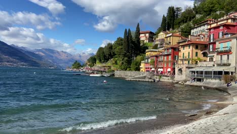 Panning-shot-revealing-picturesque-waterfront-Italian-village-of-Varenna-in-Como-lake
