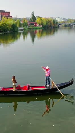 aerial view of gondola ridingon river. gondoliers with gondola sailing with tourists along the river of the city