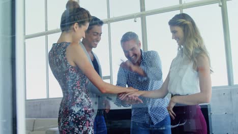 Group-of-smiling-executives-forming-hand-stack-4k