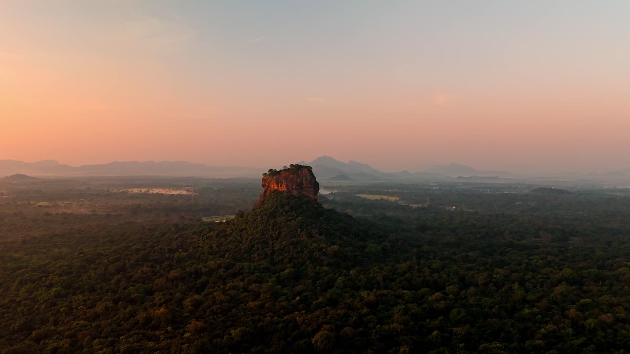 Breathtaking drone footage of Sigiriya Rock Fortress at sunrise.