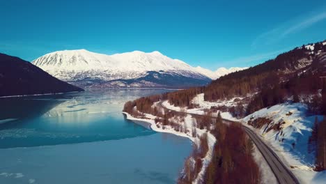 4K-Drone-Video-of-Snow-Covered-Lakeside-Mountains-in-Alaska-During-Winter