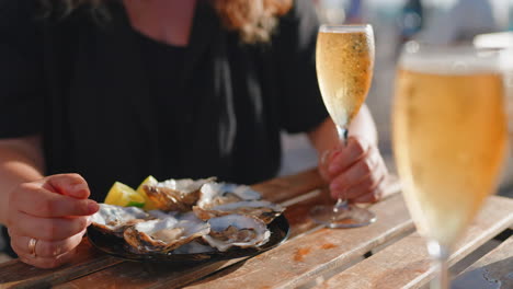 woman enjoying oysters and champagne