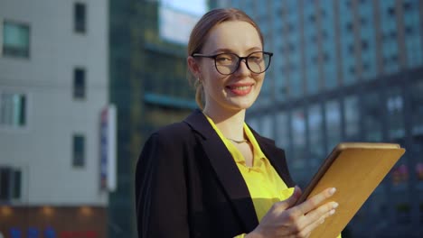 confident young woman professional looking at digital tablet