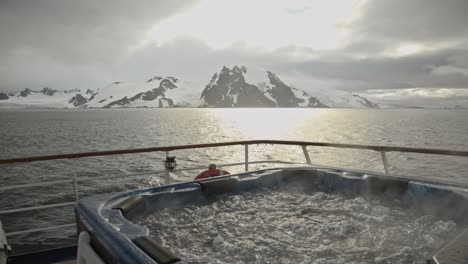 Jacuzzi-with-bubbles-and-steam-and-stunning-background-in-Antarctica-on-expedition-cruise-ship