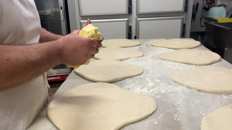 the art of artisanal bakery: baker prepares his pastry puff in his workshop