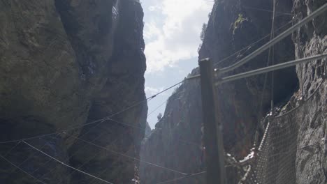 wind blowing net ropes in cave sunlight | grindelwald switzerland cave in glacier canyon, europe, 4k