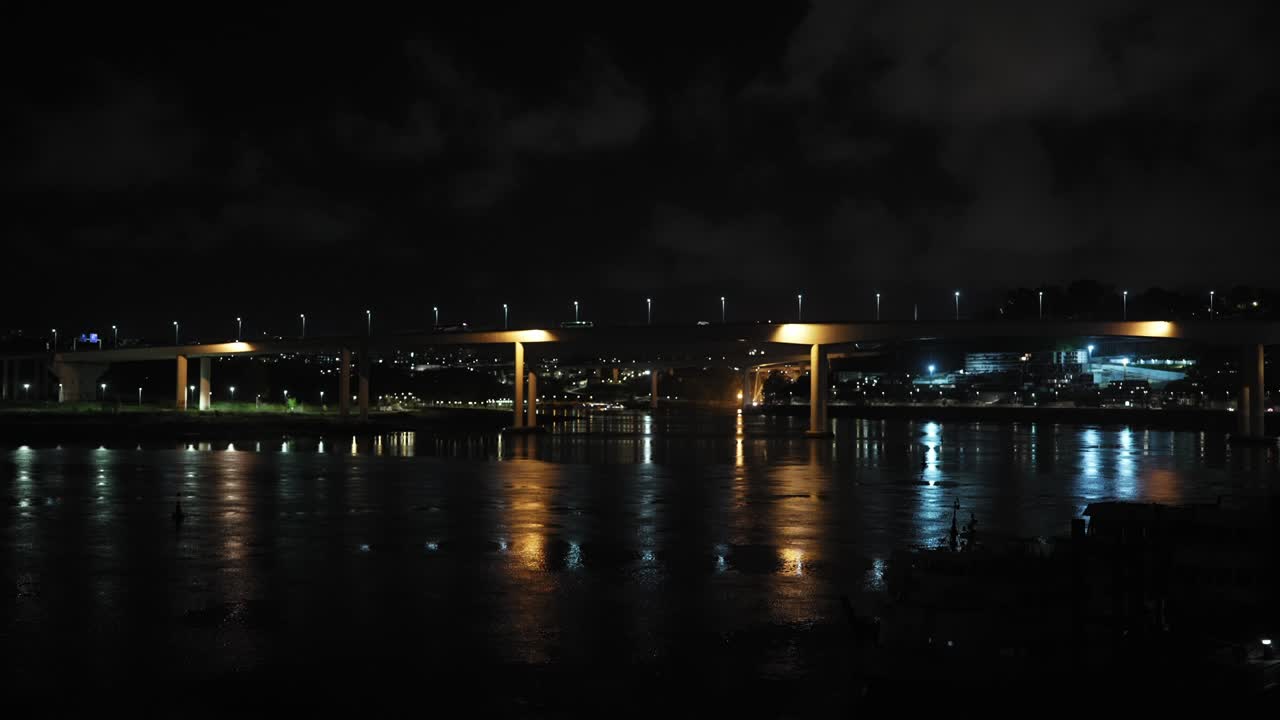 Freixo Bridge in Porto glows softly at night, its lights shimmering across the Douro River and illuminating the peaceful city skyline