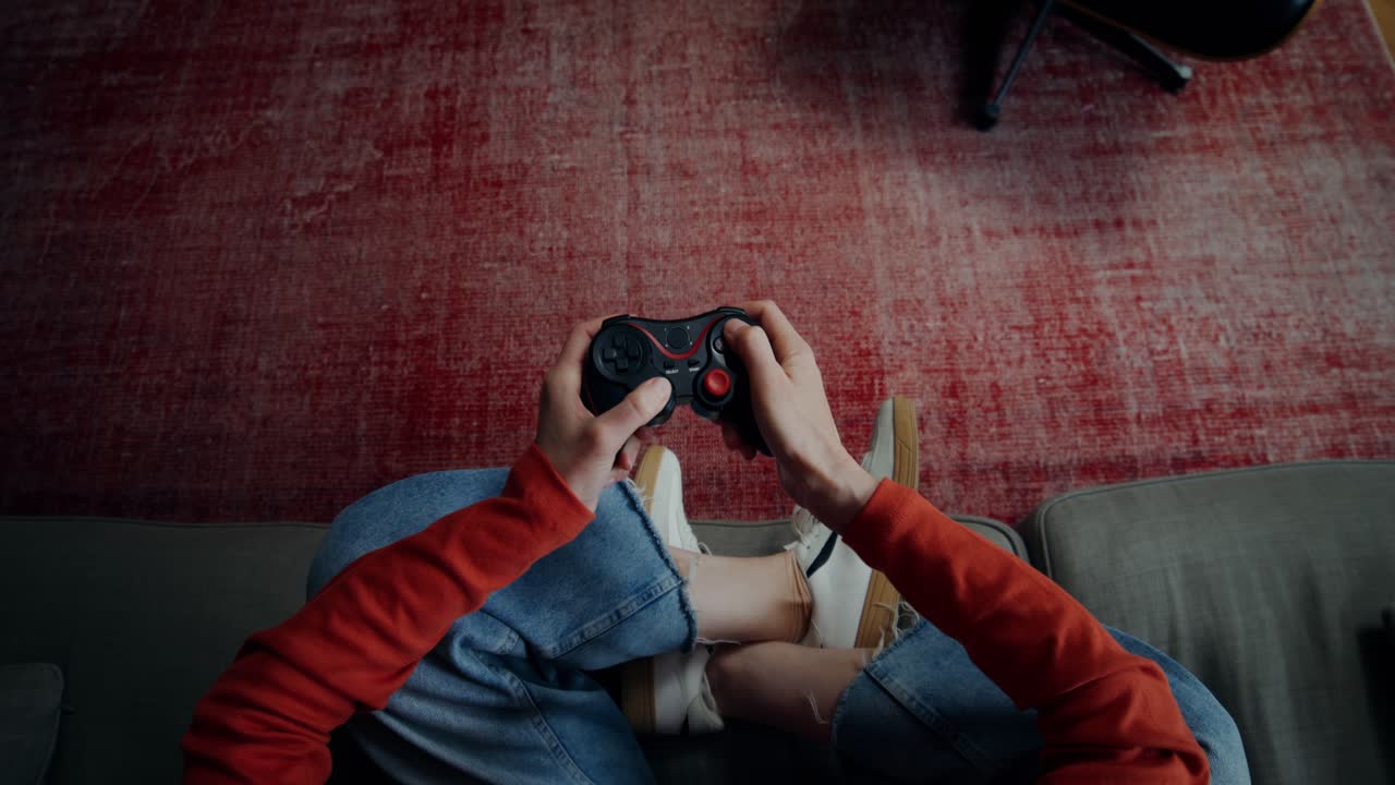 Person Playing Video Games on a Couch