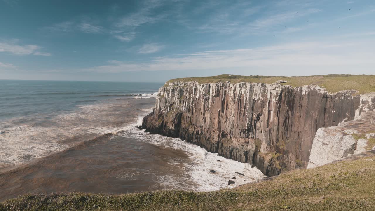 Waves crashing on high rocky cliffs on atlantic ocean
