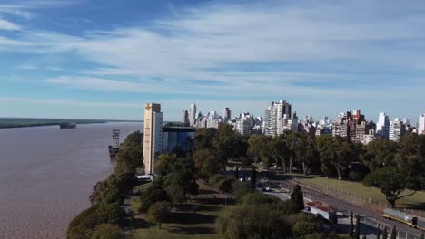 circular and downward flight on the banks of the parana river with the city of rosario in argentina