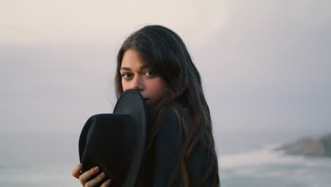 Playful-woman-posing-dusk-seashore-close-up.-Smiling-model-enjoy-calm-evening.