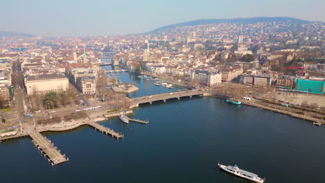 aerial golden hour of zurich cityscape with ferry, tram and traffic, switzerland