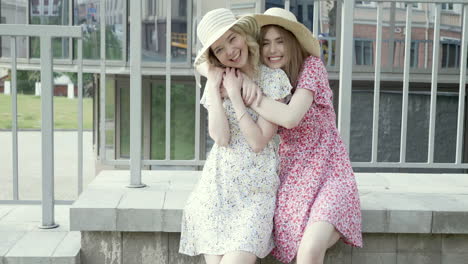 two happy friends in summer dresses