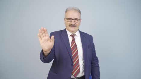 Businessman-waving-at-camera.