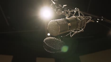 microphone in a studio. suspenden microphone. golden microfone. low angle shot. flare