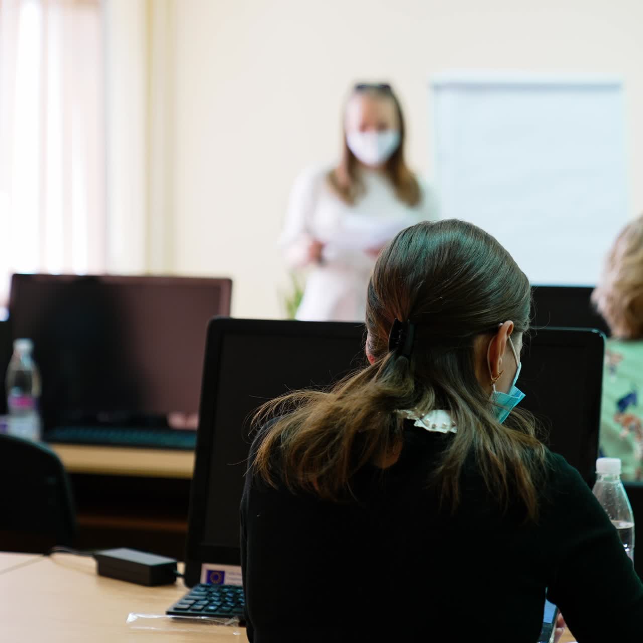Female students taking records of medical lecture. University course on ophthalmology and eye surgery